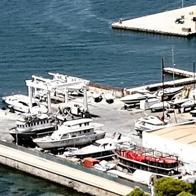 The RV Heraclitus uncovered from her cocoon with the new black-and-red hull.